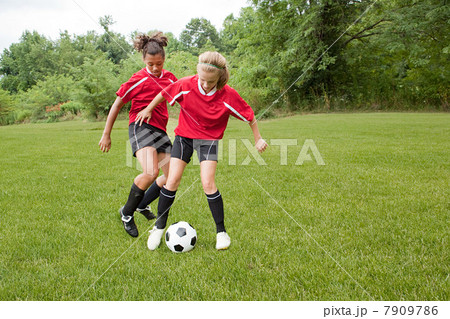 Girls playing soccer 7909786