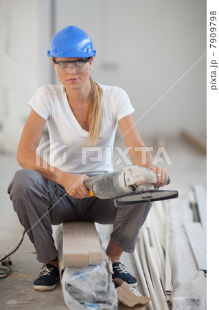 Female laborer with circular saw 7909798