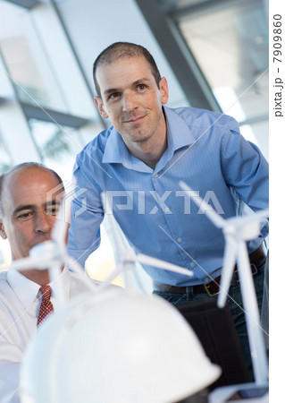 Engineers with model wind turbines 7909860