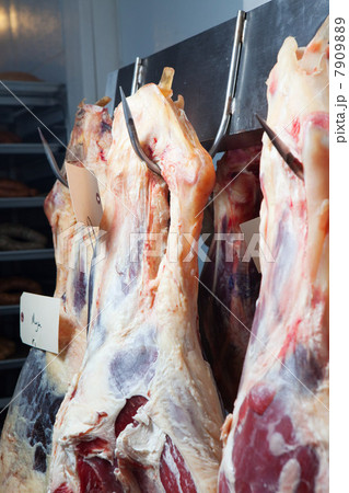 Beef hanging from meat hooks 7909889