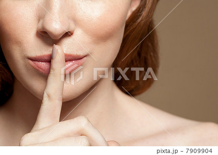 Woman with finger on lips, close up 7909904