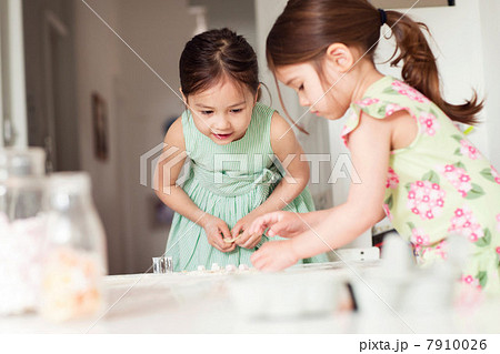 Two young sisters making pastry 7910026
