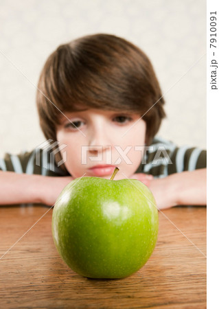 Boy staring at an apple Boy staring at an apple 7910091
