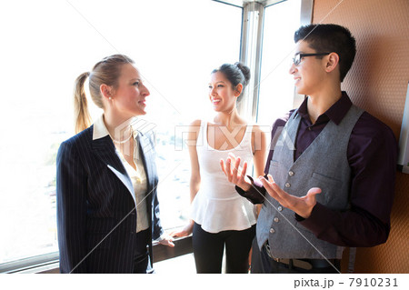 Three young businesspeople talking Three young businesspeople talking 7910231