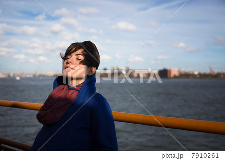 Woman on ferry in urban harbor 7910261