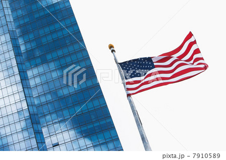 American flag flying by modern skyscraper 7910589