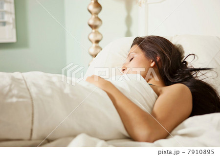 Young woman asleep in bed 7910895