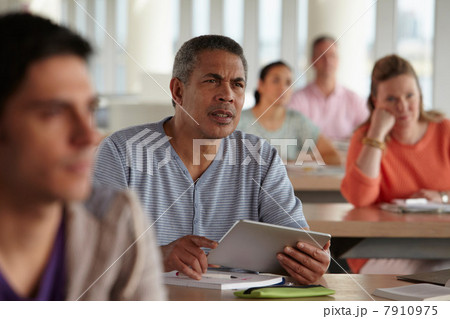 Man using digital tablet in class Man using digital tablet in class 7910975
