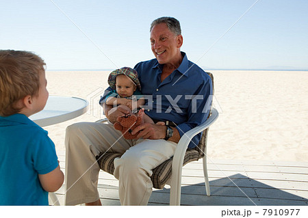 Grandfather sitting with two grandsons Grandfather sitting with two grandsons 7910977