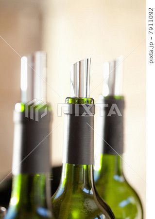 Close up of metal corks in wine bottles Close up of metal corks in wine bottles 7911092
