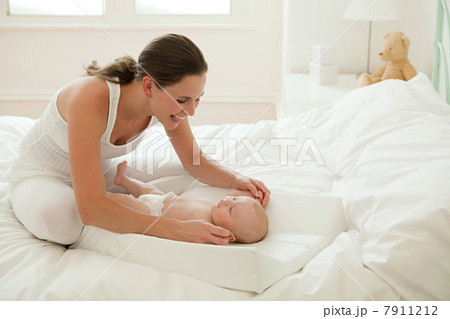 Mother with baby son on changing mat Mother with baby son on changing mat 7911212