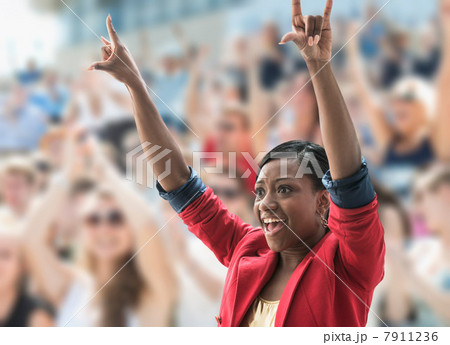 Excited woman in crowd, making hand gesture Excited woman in crowd, making hand gesture 7911236