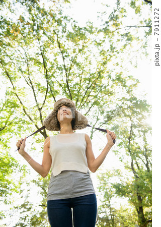 Smiling woman standing in park Smiling woman standing in park 7911272