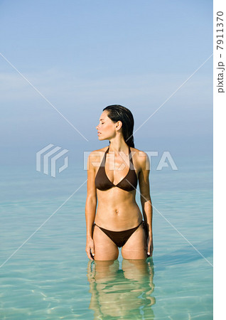 Young woman wearing bikini in sea Young woman wearing bikini in sea 7911370