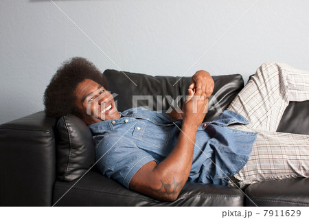 Mature man relaxing on sofa, portrait Mature man relaxing on sofa, portrait 7911629