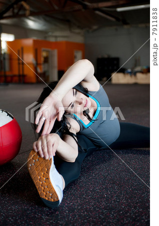 Pregnant young woman stretching to touch toes Pregnant young woman stretching to touch toes 7911838