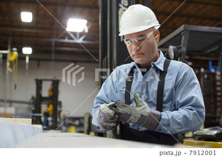 Worker with gloves in metal plant Worker with gloves in metal plant 7912001