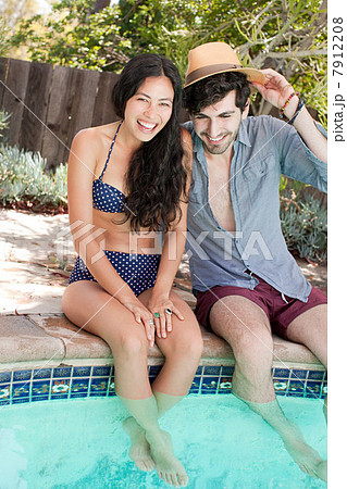 Young couple in swimming pool on vacation 7912208