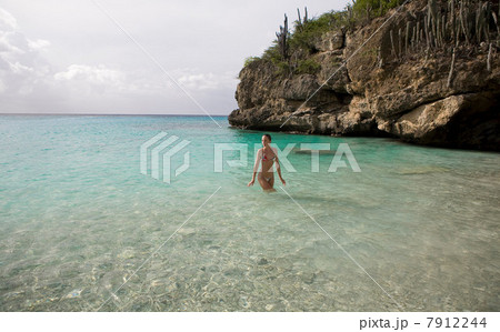 Woman walking in tropical water Woman walking in tropical water 7912244