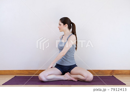 Woman stretching during yoga Woman stretching during yoga 7912413