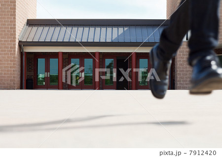 Male high school student running away from school 7912420