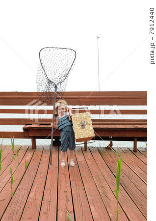 Girl carrying net and picnic basket 7912440