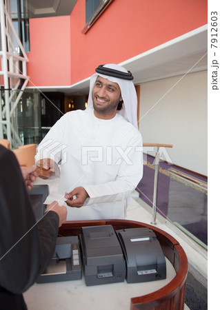 Middle eastern businessman making transaction 7912603
