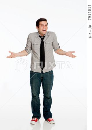 Young man shrugging shoulders against white background Young man shrugging shoulders against white background 7912615