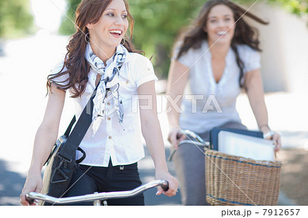Women riding bicycles in park 7912657