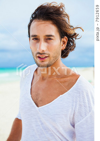 Portrait of a man on beach 7912659