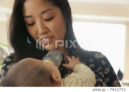 Close up of mother feeding baby daughter Close up of mother feeding baby daughter 7912752