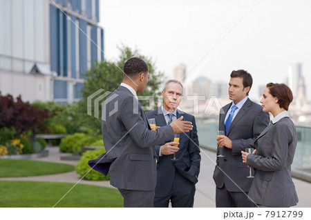 Businessmen outside with drinks 7912799