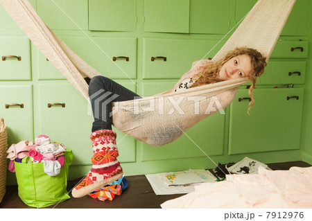 Teenage girl lying in hammock, portrait 7912976