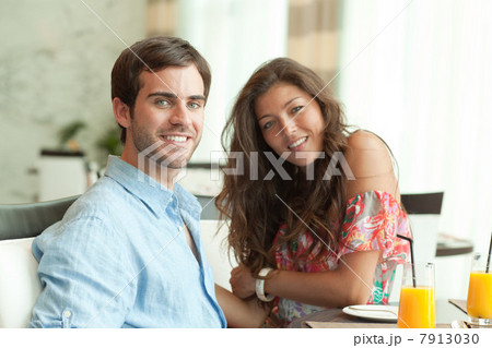 Young couple at dining table Young couple at dining table 7913030