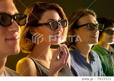 Row of people watching 3D movie, woman with popcorn Row of people watching 3D movie, woman with popcorn 7913523