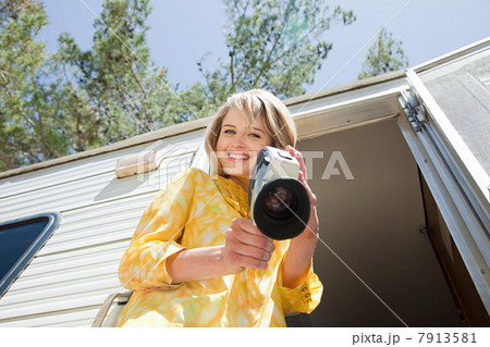 Young woman with a video camera 7913581