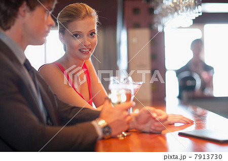 Couple having drinks at bar 7913730