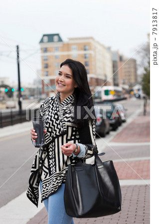 Young woman carrying travel mug 7913817