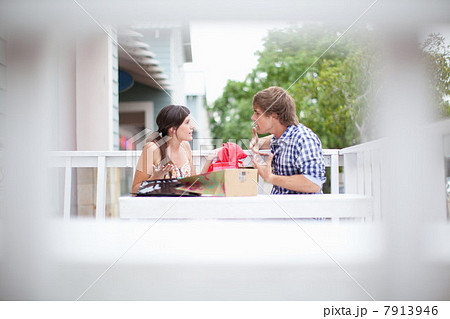 Couple examining shopping bags together Couple examining shopping bags together 7913946