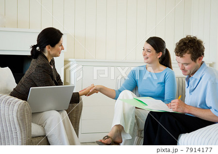 Couple meeting financial advisor at home 7914177