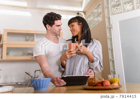 Young couple with digital tablet in kitchen Young couple with digital tablet in kitchen 7914415
