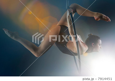 Side view of aerialist performing on hoop 7914451