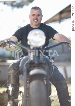 Man sitting on motorcycle Man sitting on motorcycle 7914645