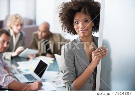 Businesswoman smiling in office doorway 7914807