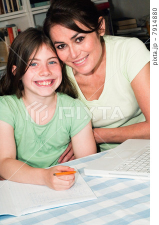 Mother helping daughter with homework 7914880
