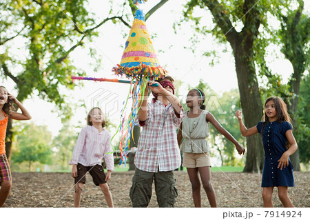 Boy at birthday party hitting pinata Boy at birthday party hitting pinata 7914924