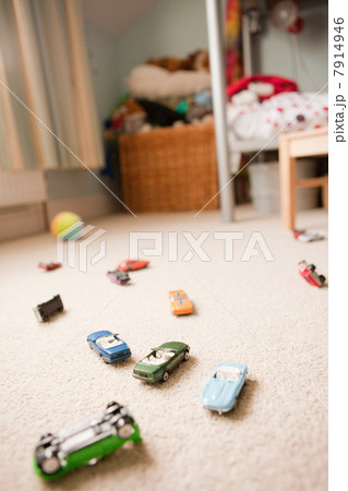 Toy cars scattered across a child's bedroom Toy cars scattered across a child's bedroom 7914946