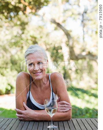 Mature woman outdoors with wine 7915060