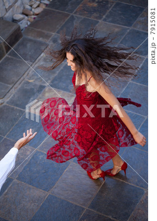 Woman in gown spinning outdoors Woman in gown spinning outdoors 7915081