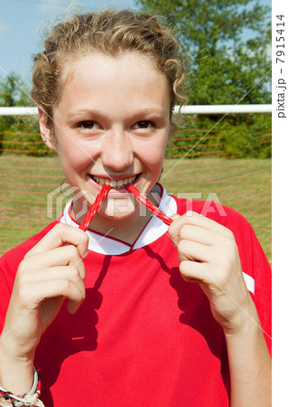 Girl soccer player eating sweet Girl soccer player eating sweet 7915414